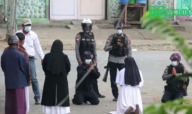 Suster Rose: Jika Anda Perlu Membunuh, Silakan Tembak Saya Suster Rose berlutut di tanah, dengan tangan terbuka lebar, memohon para perwira agar para tentara meninggalkan kompleks Gereja.